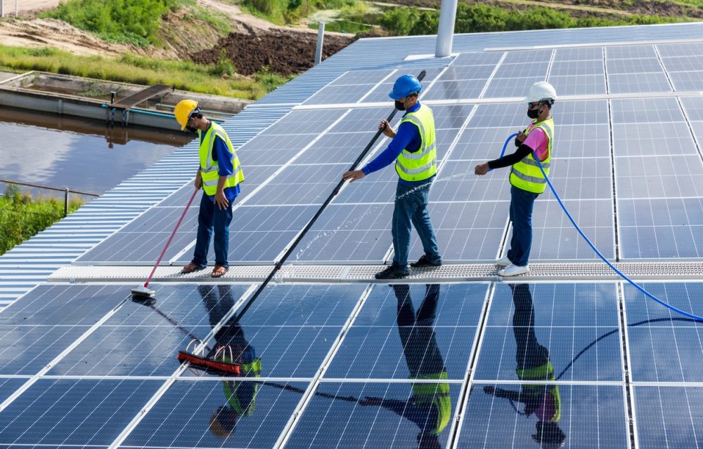 three-workers-cleaning-solar-panels